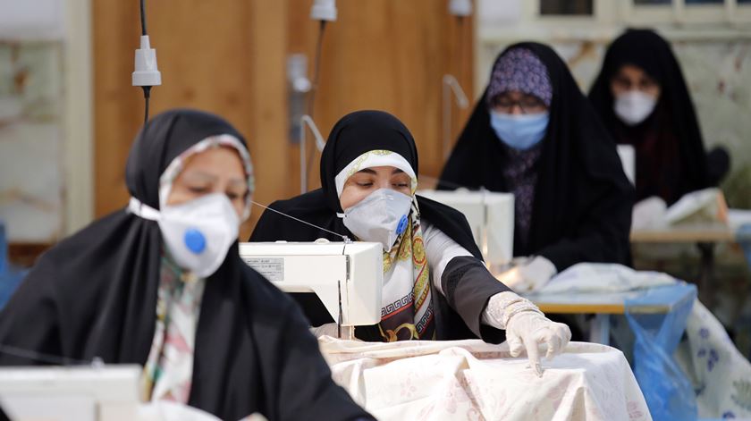 Membros das forças paramilitares iranianas produzem máscaras e outros materiais de proteção, no interior de uma mesquita, em Teerão (Abril de 2020). Foto: Abedin Taherkenareh/EPA