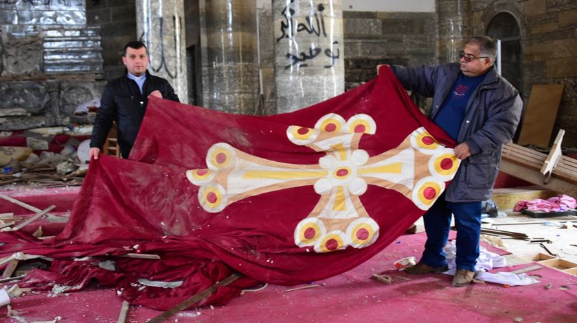 Cristãos numa igreja vandalizada no Iraque, cuja reconstrução foi financiada pela AIS. Foto: AIS